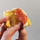 hand holding stuffed pizza crust